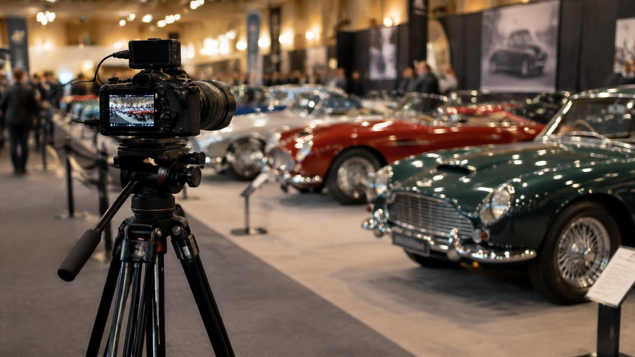 Professional camera equipment set up at a classic car exhibition event