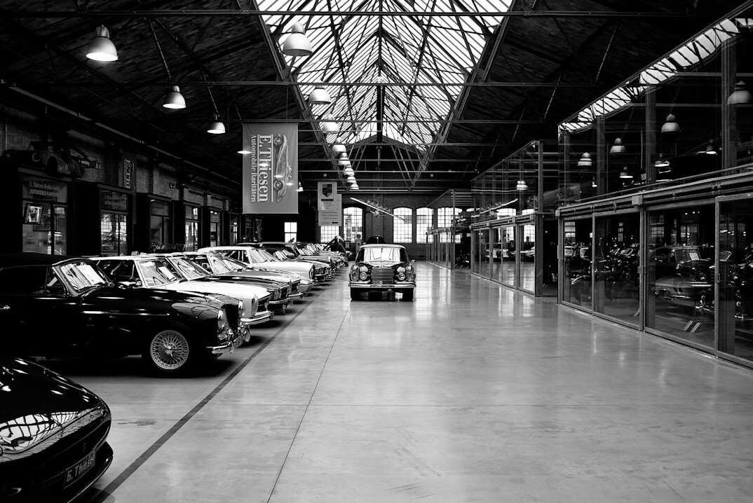 Archive room with black and white photographs of historic automobiles